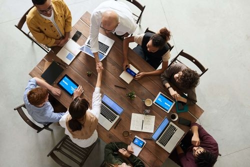 workers doing business sat around a desk